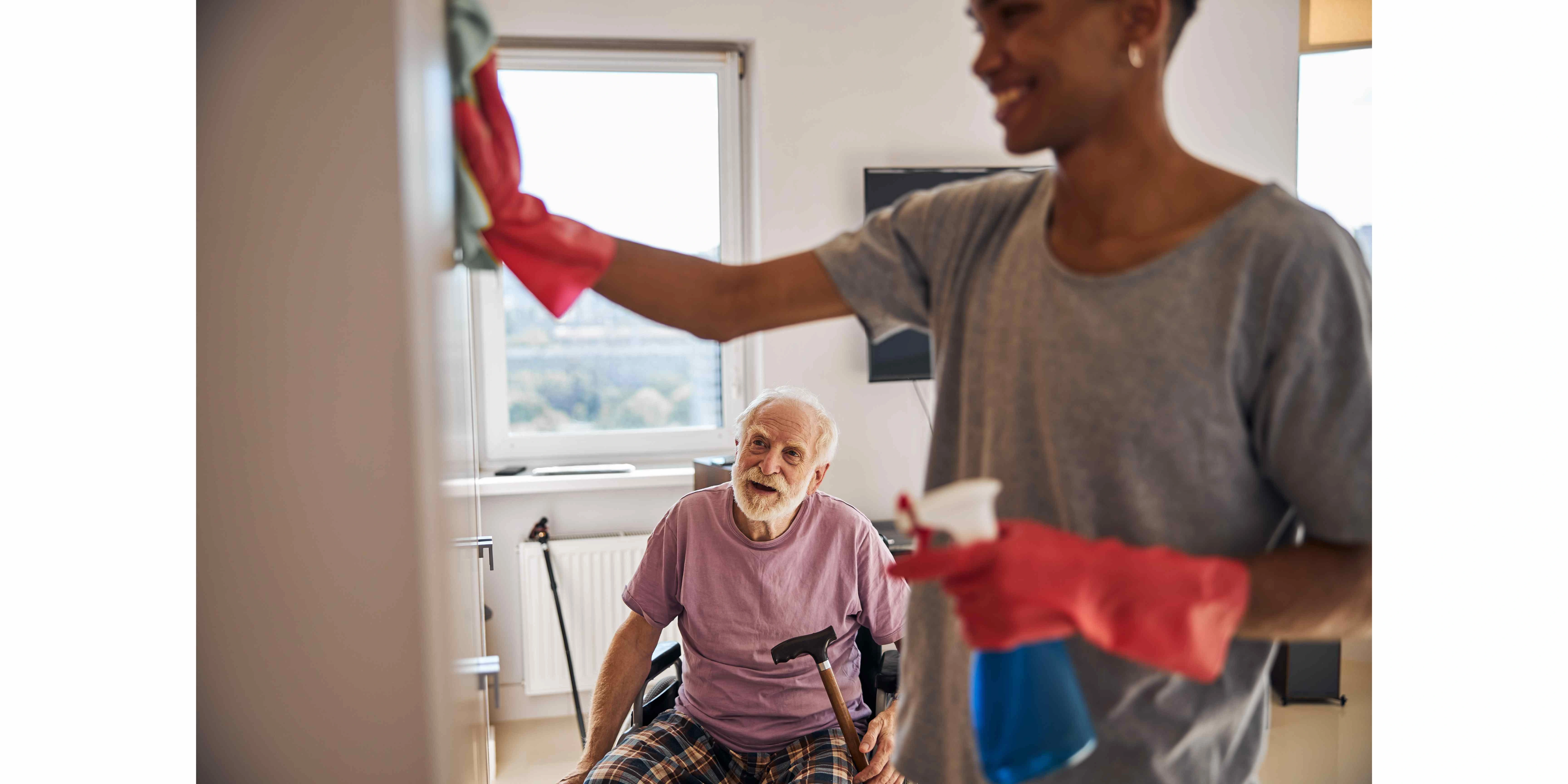 volunteer helping a disabled person clean his home