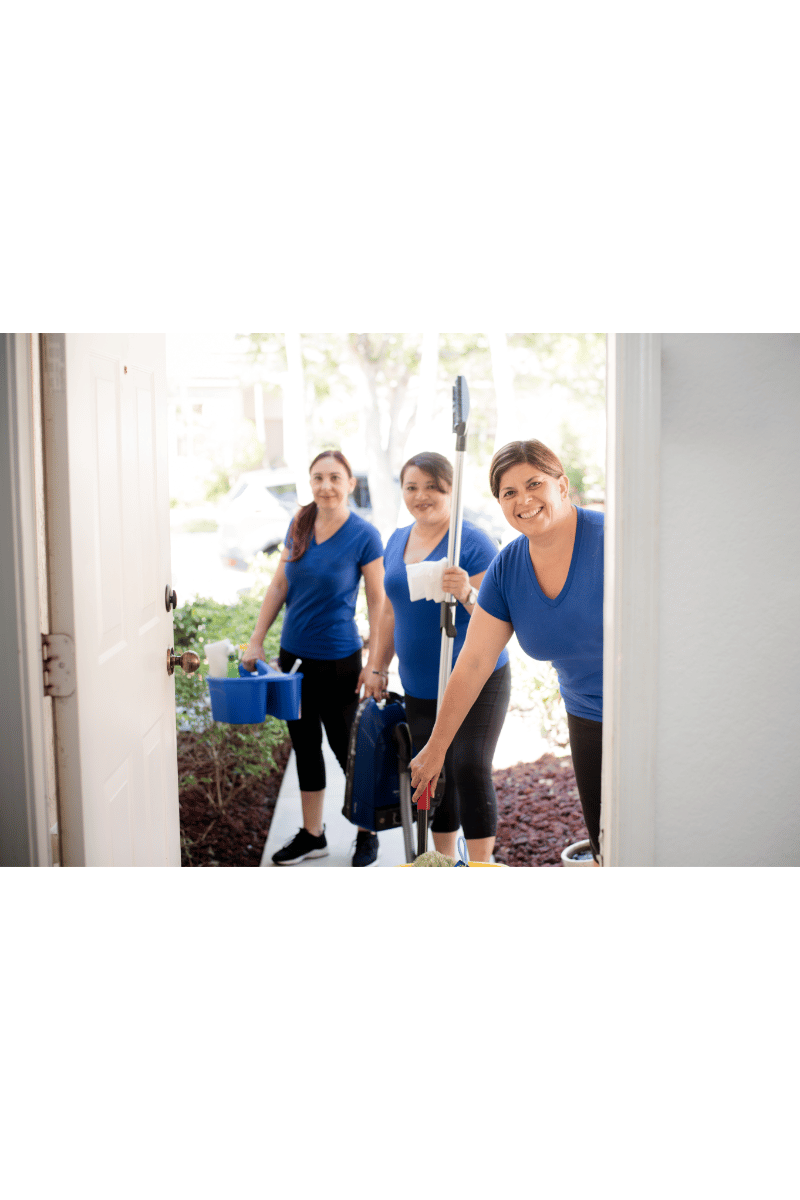 female cleaners standing by the doorstep