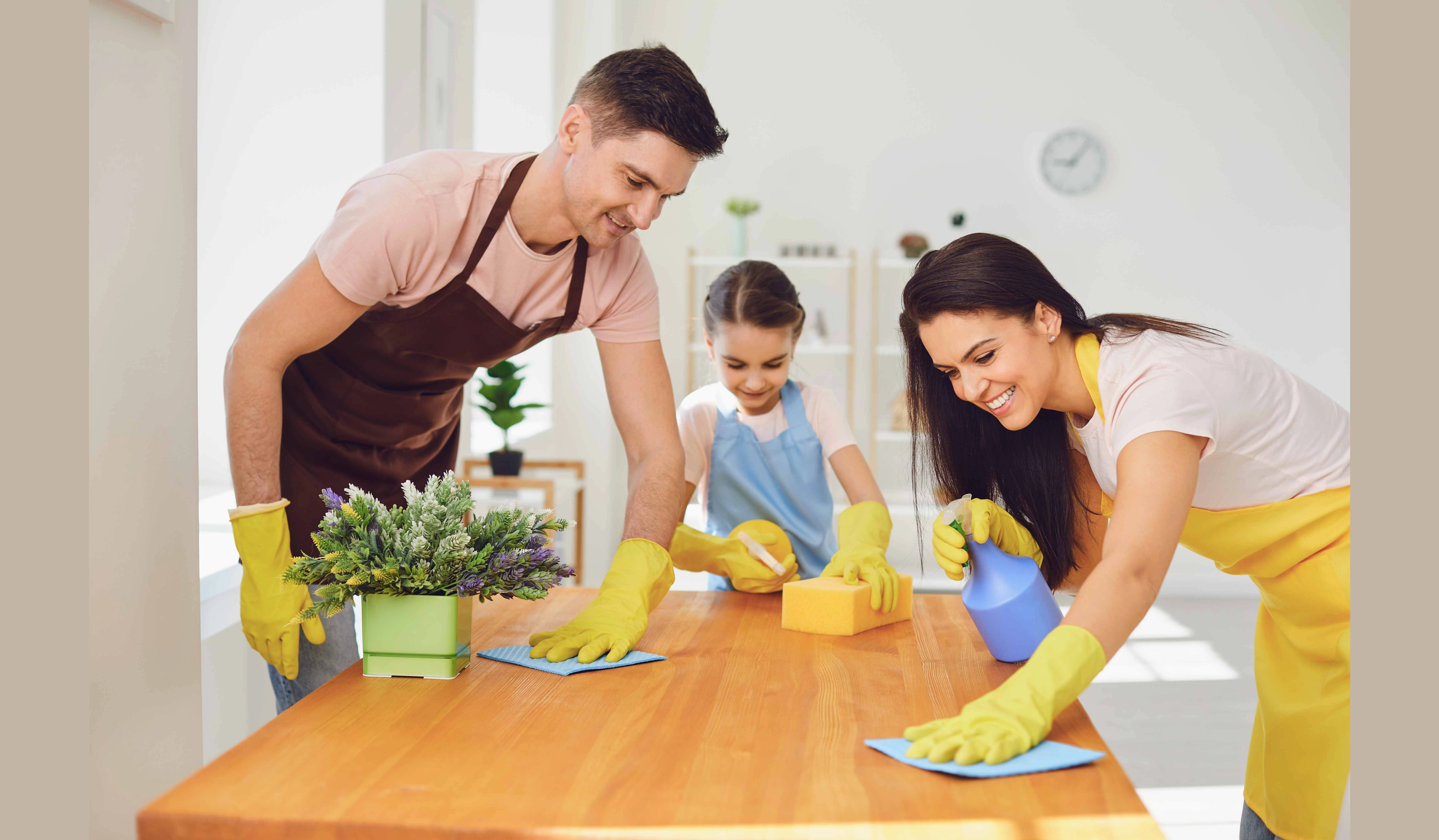 family cleaning a dining table