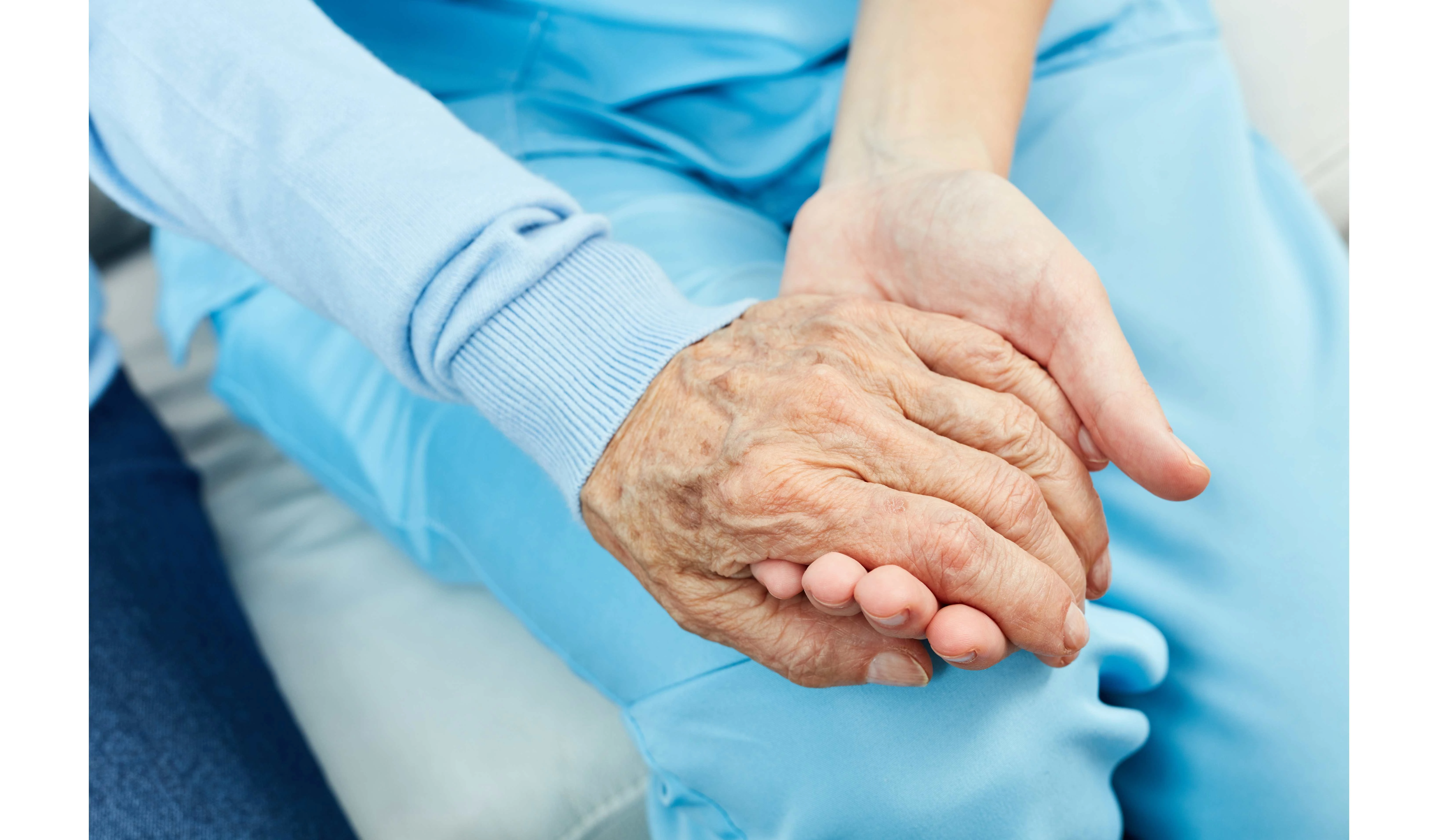 two hands holding in a caring way