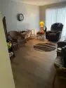 An organized living room in an apartment after a move out cleaning provided by The CoBuilders professional