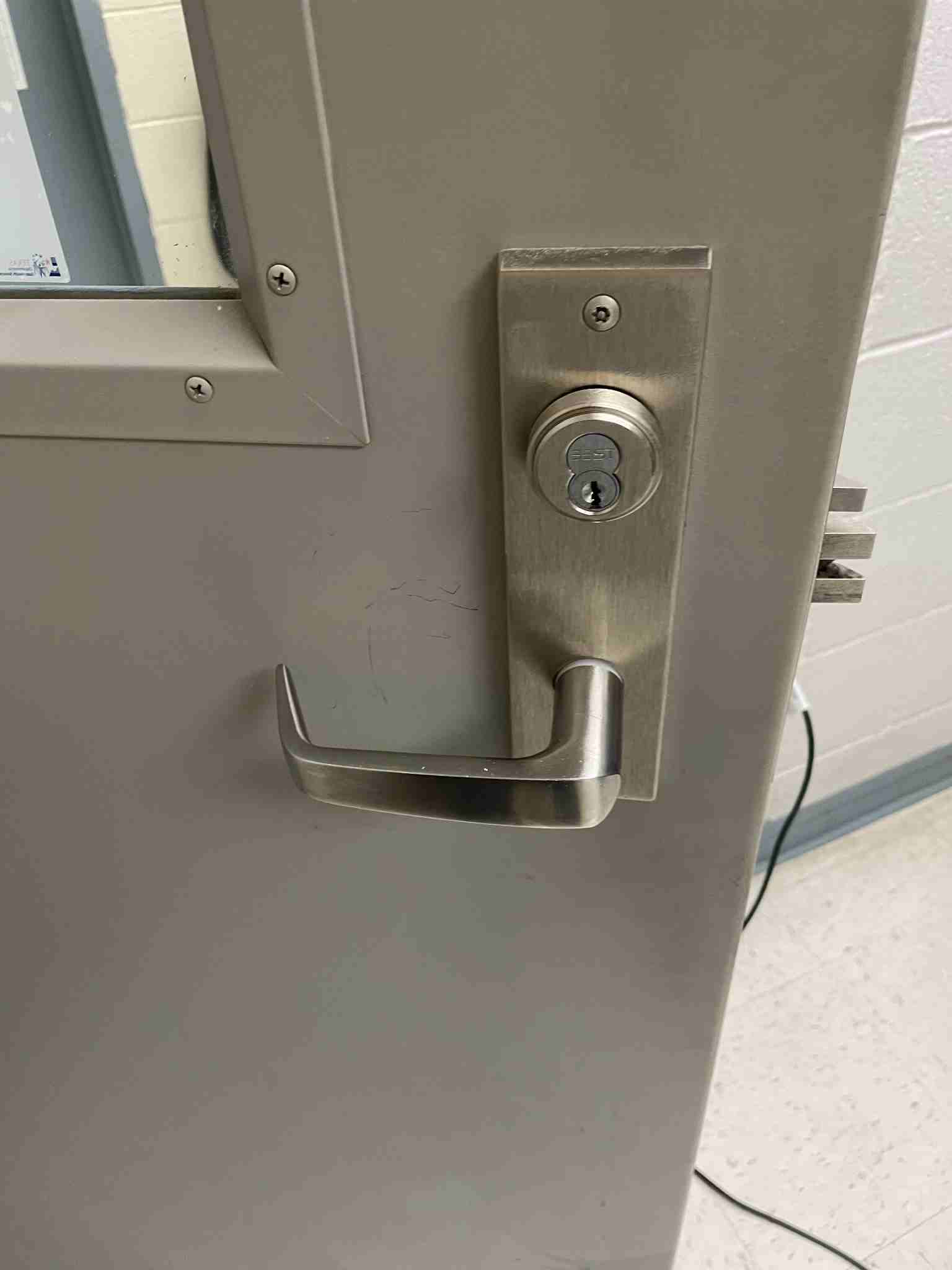 High-touch stainless steel door handle— a common hotspot for germs and bacteria. Regular disinfection is essential for maintaining hygiene and preventing disease spread