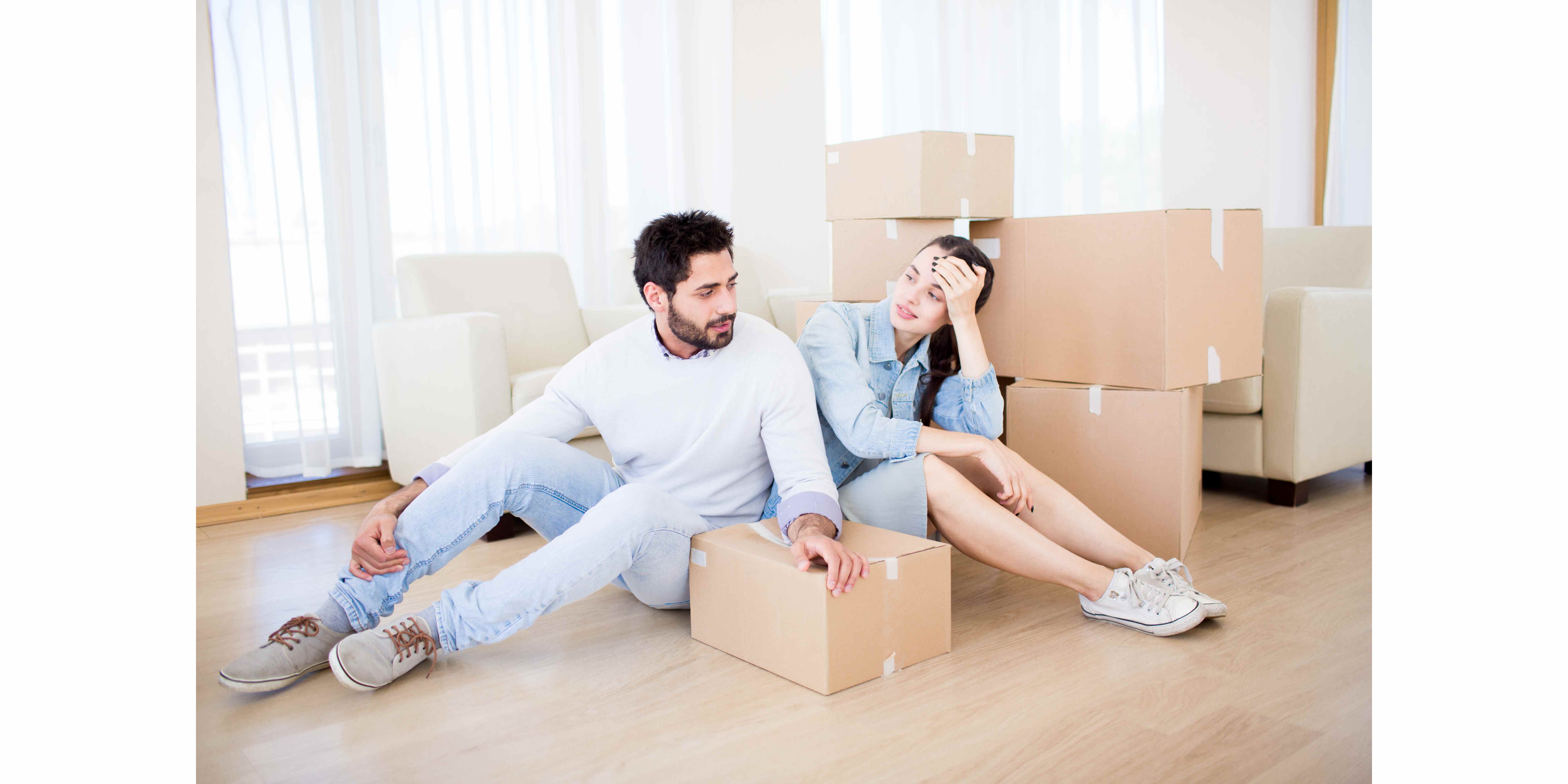 a couple unpacking boxes after a move